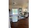 Cozy living room featuring a ceiling fan, comfortable seating, hardwood flooring and view of backyard at 10411 Sw 52Nd Ct, Ocala, FL 34476