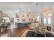 Open-concept living room flows into kitchen, with stylish furnishings and natural light at 10411 Sw 52Nd Ct, Ocala, FL 34476