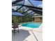 Refreshing screened-in pool with a relaxing outdoor seating area, perfect for unwinding or entertaining at 10411 Sw 52Nd Ct, Ocala, FL 34476