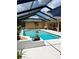 Inviting screened-in pool with clear blue water and surrounding patio, perfect for relaxation and entertaining at 10411 Sw 52Nd Ct, Ocala, FL 34476