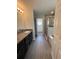 Modern bathroom featuring double vanities, a glass-enclosed shower, and a separate tub at 7051 Sw 64Th Ter, Ocala, FL 34476