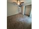 Neutral bedroom featuring a ceiling fan, carpeted floors, and a walk-in closet at 7051 Sw 64Th Ter, Ocala, FL 34476