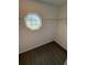 Walk-in closet with vinyl flooring and shelving, featuring a unique octagon-shaped window for natural light at 7051 Sw 64Th Ter, Ocala, FL 34476