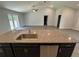 Open concept kitchen features stainless steel appliances, granite countertops, and views of the living area and backyard at 7051 Sw 64Th Ter, Ocala, FL 34476