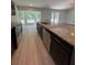 Open concept kitchen with granite counters, modern appliances and a breakfast bar island at 7051 Sw 64Th Ter, Ocala, FL 34476