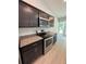 Modern kitchen showcasing stainless steel appliances, granite countertops, and dark wood cabinetry at 7051 Sw 64Th Ter, Ocala, FL 34476