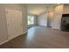Open-concept living room with gray floors and modern chandelier at 7051 Sw 64Th Ter, Ocala, FL 34476