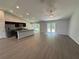 Spacious living room featuring an open-concept kitchen with modern appliances, recessed lighting, and luxury vinyl flooring at 7051 Sw 64Th Ter, Ocala, FL 34476
