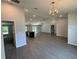 Open concept living space featuring modern floors, a kitchen island, and large windows at 7051 Sw 64Th Ter, Ocala, FL 34476