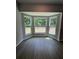 Bright sunroom featuring three windows offering panoramic views of the surrounding landscape at 7051 Sw 64Th Ter, Ocala, FL 34476