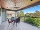 A covered balcony with tile flooring, a ceiling fan, and an ornate wrought iron railing at 10621 Sw 11Th Ter, Ocala, FL 34476