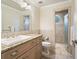 Bathroom featuring a sink with granite countertop and a shower with tiled walls at 10621 Sw 11Th Ter, Ocala, FL 34476