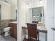 Bright bathroom featuring a vanity area, granite countertops, and modern fixtures at 10621 Sw 11Th Ter, Ocala, FL 34476