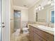 Well-lit bathroom with a glass shower, granite countertops, and light-colored tile at 10621 Sw 11Th Ter, Ocala, FL 34476