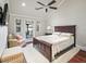 Bedroom with hardwood floors, a ceiling fan, and access to a balcony at 10621 Sw 11Th Ter, Ocala, FL 34476