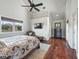 Bedroom with vaulted ceilings, hardwood floors, natural light, and dedicated entertainment area at 10621 Sw 11Th Ter, Ocala, FL 34476