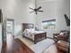 Vaulted ceiling bedroom with a ceiling fan, dark wood floors, and a seating area at 10621 Sw 11Th Ter, Ocala, FL 34476