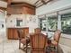 Bright dining area with a bar, natural light, four chairs and a ceiling fan at 10621 Sw 11Th Ter, Ocala, FL 34476