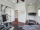 Bright exercise room featuring workout equipment, hardwood floors, and crown molding at 10621 Sw 11Th Ter, Ocala, FL 34476