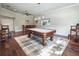 Spacious game room featuring a pool table, bar area, and hardwood flooring at 10621 Sw 11Th Ter, Ocala, FL 34476