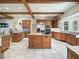 Spacious kitchen with a center island, stainless steel appliances, wood beams and tile floors at 10621 Sw 11Th Ter, Ocala, FL 34476