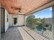 Covered patio with decorative railing offering stunning views of the surrounding landscape at 10621 Sw 11Th Ter, Ocala, FL 34476