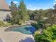 Aerial view of a pool surrounded by lush landscaping, trees and a backyard oasis at 10621 Sw 11Th Ter, Ocala, FL 34476