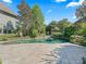 Backyard pool with lush landscaping, greenery, and a blue sky at 10621 Sw 11Th Ter, Ocala, FL 34476