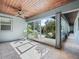 View of a screened-in porch with plants and a wood ceiling at 10621 Sw 11Th Ter, Ocala, FL 34476