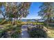 Backyard with lake view, stone patio, and lush landscaping at 22345 Ne 108Th Avenue Rd, Fort Mc Coy, FL 32134
