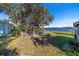 Backyard with lake view and stone patio seating area at 22345 Ne 108Th Avenue Rd, Fort Mc Coy, FL 32134