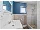 Small bathroom with white vanity, stone-patterned tile, and shower at 22345 Ne 108Th Avenue Rd, Fort Mc Coy, FL 32134