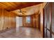 Bedroom with wood paneled walls, tiled floors, and built-in closets at 22345 Ne 108Th Avenue Rd, Fort Mc Coy, FL 32134