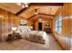 Main bedroom with wood walls, tiled floors, and a dresser at 22345 Ne 108Th Avenue Rd, Fort Mc Coy, FL 32134