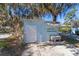 Small light blue shed with sink and shelving in the backyard at 22345 Ne 108Th Avenue Rd, Fort Mc Coy, FL 32134