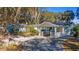 Light blue house with white accents, carport, and mature trees at 22345 Ne 108Th Avenue Rd, Fort Mc Coy, FL 32134
