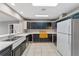 Kitchen with dark cabinets, white countertops, and stainless steel appliances at 22345 Ne 108Th Avenue Rd, Fort Mc Coy, FL 32134