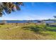 Lakefront property with grassy yard and distant docks at 22345 Ne 108Th Avenue Rd, Fort Mc Coy, FL 32134