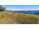 Lakefront view with grassy area and a wooden dock at 22345 Ne 108Th Avenue Rd, Fort Mc Coy, FL 32134