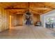 Living room with stone fireplace and vaulted wood ceiling at 22345 Ne 108Th Avenue Rd, Fort Mc Coy, FL 32134