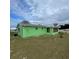 Single story green home with screen room, light shingles, and freshly mowed lawn under cloudy skies at 10300 Sw 98Th Ter, Ocala, FL 34481