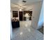 Open floor plan showing kitchen and dining space with tile flooring and ceiling fan at 10300 Sw 98Th Ter, Ocala, FL 34481