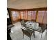 Enclosed sun room with bamboo shades, tile floor, table and chairs at 10300 Sw 98Th Ter, Ocala, FL 34481