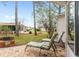 Inviting patio space with comfortable lounge chairs surrounded by lush landscaping and mature trees at 8447 Se 137Th Loop, Summerfield, FL 34491