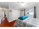 Bedroom with a double bed and a bright window, showing off the polished hardwood floors at 8447 Se 137Th Loop, Summerfield, FL 34491