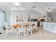 Eat-in kitchen and dining area featuring tile flooring and white cabinetry with modern appliances at 8447 Se 137Th Loop, Summerfield, FL 34491