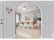 Bright dining area featuring white cabinets, a light ceiling fan, and a wooden table at 8447 Se 137Th Loop, Summerfield, FL 34491