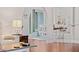 Open-concept dining area with stylish white furniture, tile floor, and backyard view at 8447 Se 137Th Loop, Summerfield, FL 34491