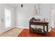 Inviting foyer with decorative door, tile entry, and wooden accent table with Americana decor at 8447 Se 137Th Loop, Summerfield, FL 34491