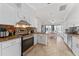 Modern kitchen with granite countertops, stainless steel appliances, and tile floors at 8447 Se 137Th Loop, Summerfield, FL 34491